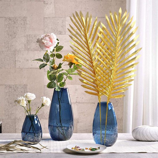 Feuilles de palmier Plante artificielle  dans vase bleu sur la table
